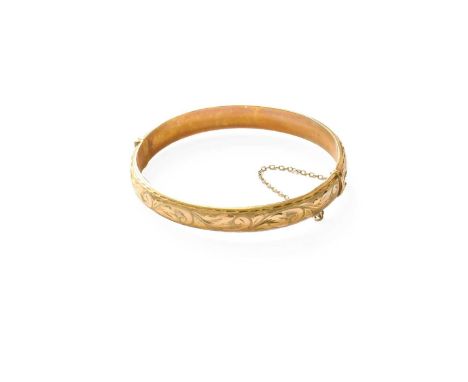 A 9 Carat Gold Hinged Bangle, inner measurements 5.8cm by 5.5cmGross weight 10.6 grams.