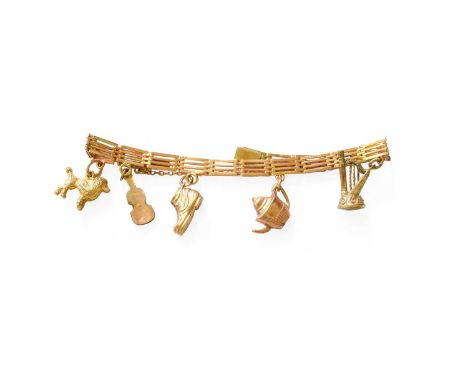 A Gate Link Bracelet, suspending five charms including a boot, a harp etc, length 17.6cmBracelet indistinctly marked, in our 