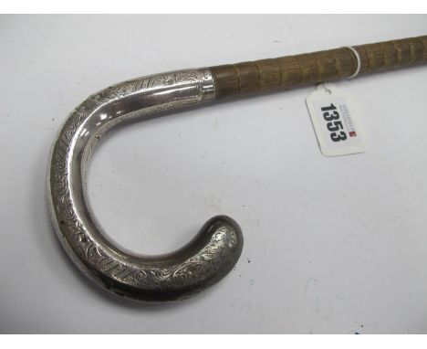 Walking Cane, circa 1900, with ribbed body and engraved silver crook handle.Lot 1353 - very dented and knocked, brass end rus