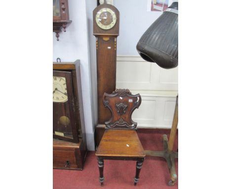 A XIX Century Oak Hall Chair, with a shaped scroll back, solid seat, on turned forefront legs; together with a 1930's oak gra