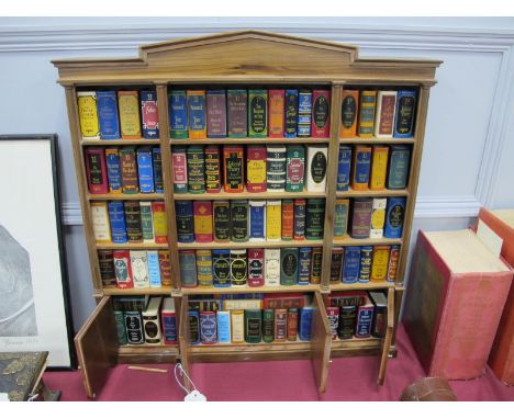 Del Prado The Miniature Classics Library, of approximately ninety five books in display shelf in a cabinet, 52cm wide.