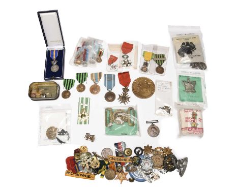 A quantity of medals and badges, and associated militaria, including: a Belgian Croix de Guerre; various awards of the French