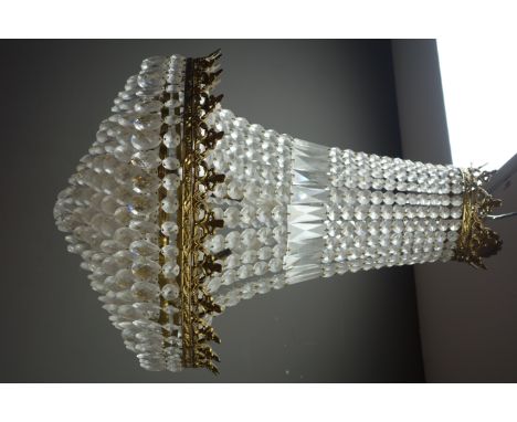 Gilt metal six light chandelier or cornet form, hung with cascading glass drops and strings of faceted cut glass beads, H72cm