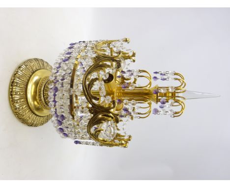 Gilt metal table lamp hung with three tiers of clear and amethyst crystal drops, with four branches on a reeded stem and circ