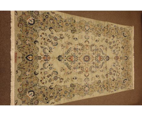 Persian Kashan carpet, pale pistachio green ground with blue  interlacing scrolled design, floral motifs, signed in red, 410c