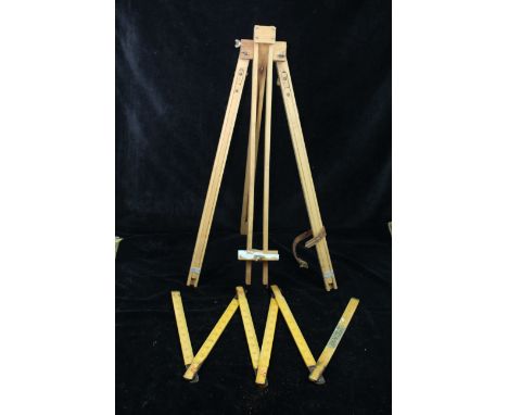 A folding artists easel; and a folding wooden and brass rule (2)