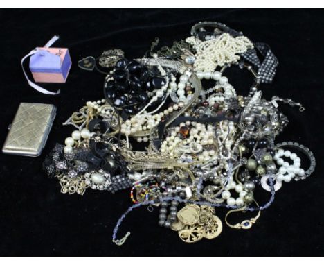 A large bag of costume jewellery, including a large paste and black enamel peacock brooch