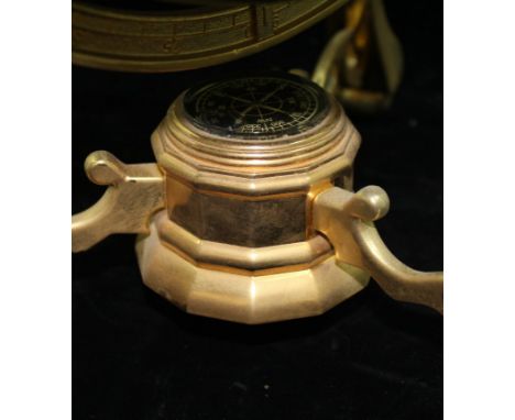 A modern Chinese terrestrial globe, inlaid with simulated semi-precious stones with a brass axis cage, compass below, 36cm hi