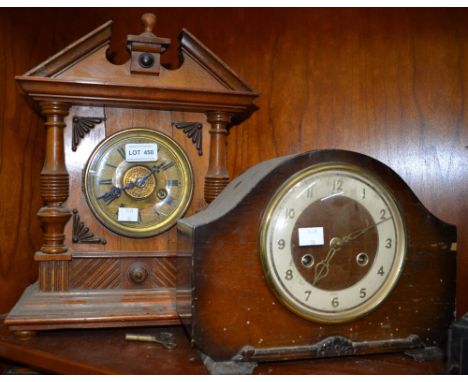 An oak bracket clock with another similar example