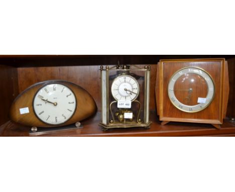 An anniversary clock with two mid-century mantle clocks