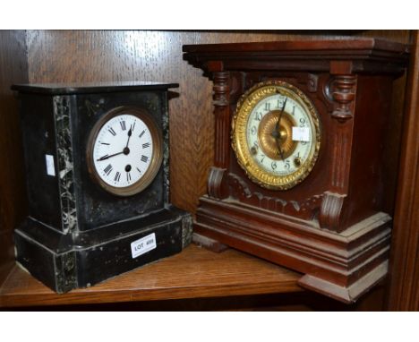 A black marble mantle clock with a wooden example
