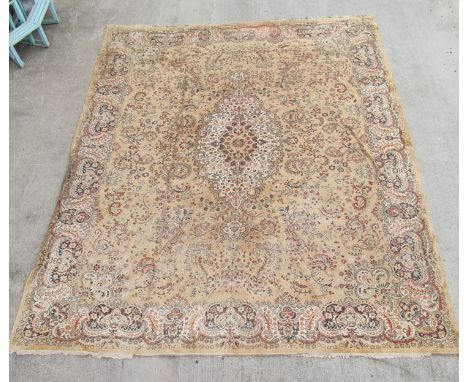 Machine woven Eastern carpet with central lozenge and foliate scrolls in creams and browns, 355cm x 450cm. 