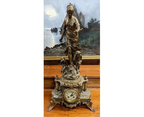 French gilt spelter and onyx figural mantle clock, the top with a standing female allegorical figure holding a conch with two