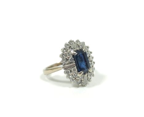 Diamond and sapphire oval cluster ring with four tapering baguettes, two rows of brilliants and rectangular sapphire in white