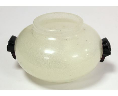 Chinese glass bowl of squat circular form, the snowflake ground with twin carved dark red overlay handles in the form of taot