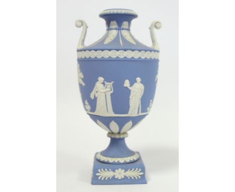 20th century Wedgwood blue jasperware vase of urn form with twin scroll handles, the continuous frieze depicting four classic