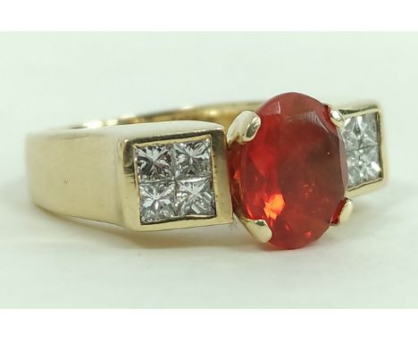 Gold ring with oval fire opal flanked by eight pavé set princess cut diamonds, probably '18k' gold, size 'O'.