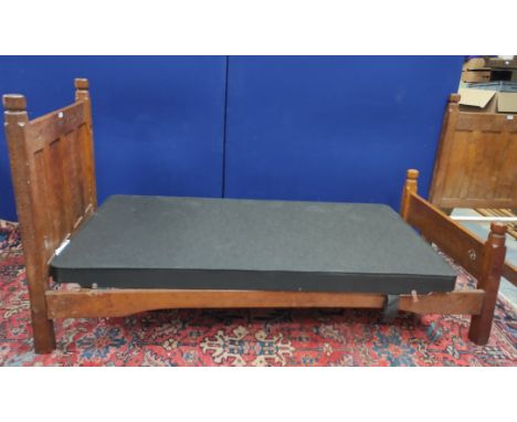 Robert "Mouseman" Thompson oak single bed, the four panel headboard inscribed "A good servant makes a good master".&nbsp;See 