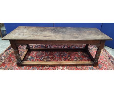 Antique oak refectory table in the 17th century style with cleated triple plank top on foliate and ring carved turned and squ