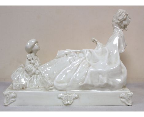 Royal Worcester white porcelain figure group of a lady and her attendant on rectangular plinth base. Unmarked and with slight