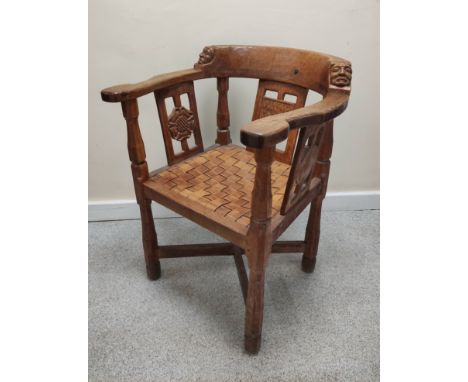 Robert "Mouseman" Thompson, "monk's" oak tub armchair, the top rail terminating in carved masks, the back and side rails with