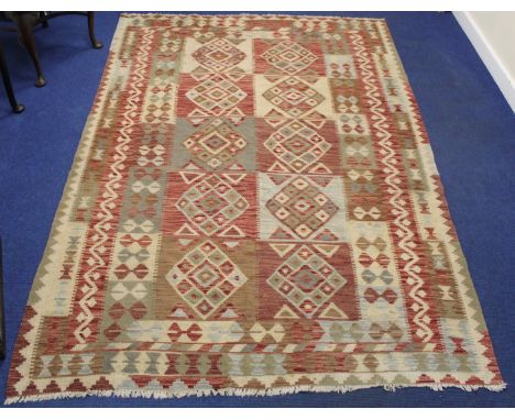 Large Kelim flat weave carpet in red, cream and grey, the main field with ten panels of diamond lozenges surrounded by multip