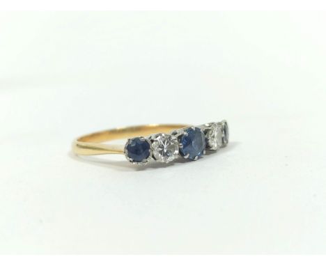 Diamond and sapphire five stone ring, two brilliants approximately .3ct in gold and platinum. Size 'R'Condition:Good conditio