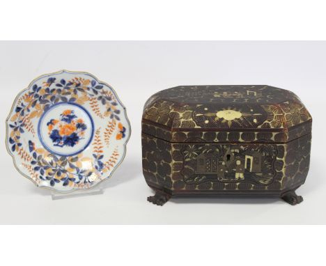 19th century Chinese black lacquer tea caddy of octagonal form with four paw feet and gilt painted panels of figures on terra