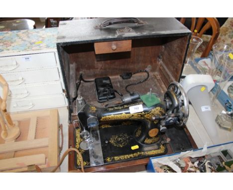 A Singer sewing machine in carrying case (sold as collectors item)