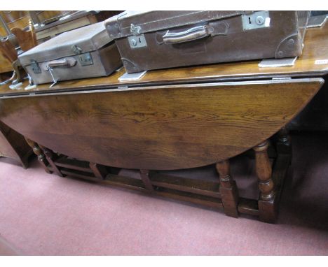 A XX Century Large Oak Double Gate Leg Table, with a oval top, on turned and block supports.