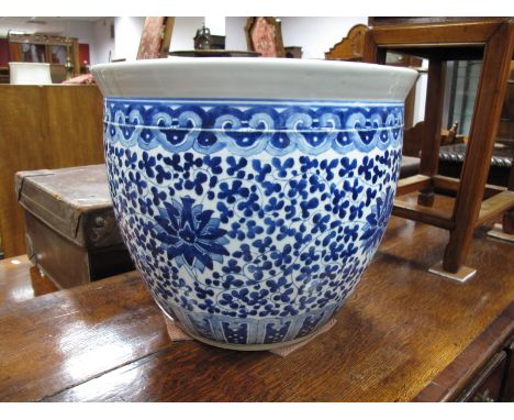 A Large Blue and White Oriental Pottery Planter, of circular form with allover floral decoration, 34.5cm high, 40cm wide.