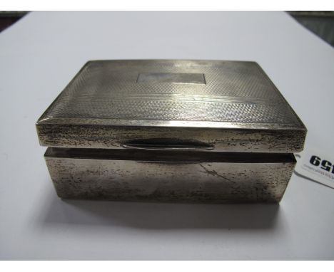 A Hallmarked Silver Cigarette Box, of rectangular form with engine turned lid, 11.5cm wide.