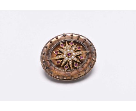 A Victorian ruby and split seed pearl mourning locket / brooch, designed as a central split seed pearl star interspersed with