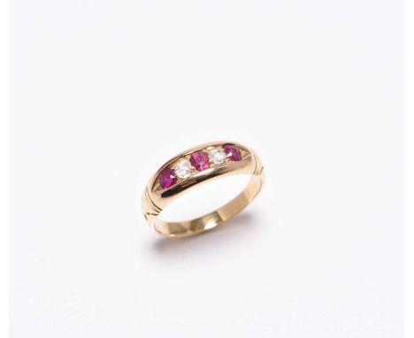 A graduated five stone diamond and untested ruby ring, claw set to tapering yellow metal band, not stamped, ring size L 1/2, 