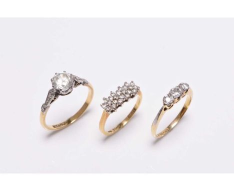 A three stone graduated diamond ring, stamped '18ct', size K 1/2, together with an 18ct gold diamond set ring, size I 1/2 and