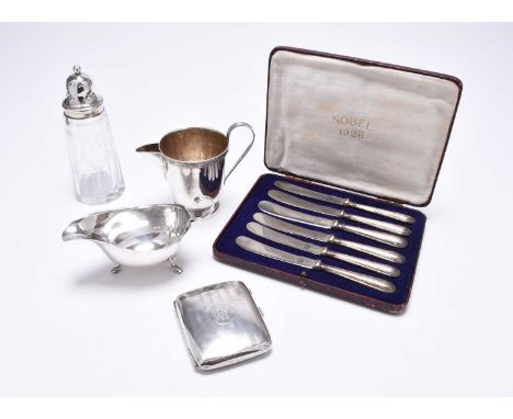 A small collection of silver, comprising; a silver cream jug/sauce boat with crimped rim, a further silver jug, a silver moun