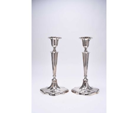 A pair of silver mounted candlesticks, Hawksworth, Eyre &amp; Co Ltd, Sheffield 1913 and 1915, each with removable drip trays