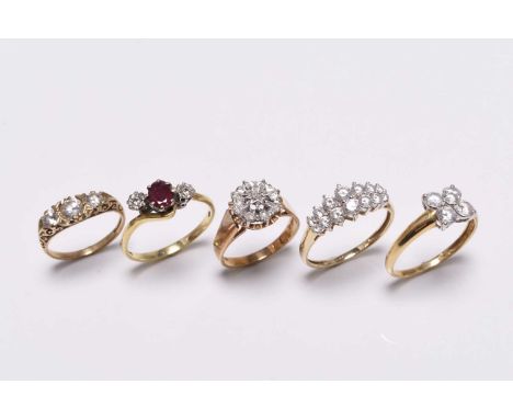 A 14ct gold stone set ring, size U, together with a 9ct gold diamond set ring, size O, a 9ct gold three stone ring, size K 1/