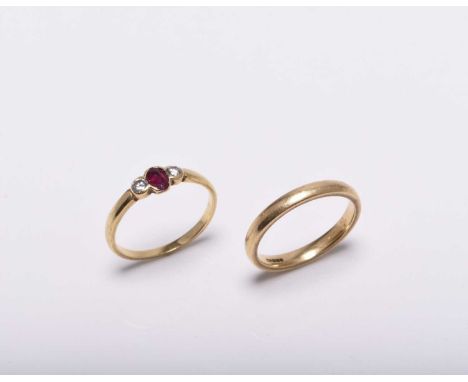 An 18ct gold wedding band, size O, together with an 18ct gold three stone ruby and diamond ring, size O 1/2, total weight app