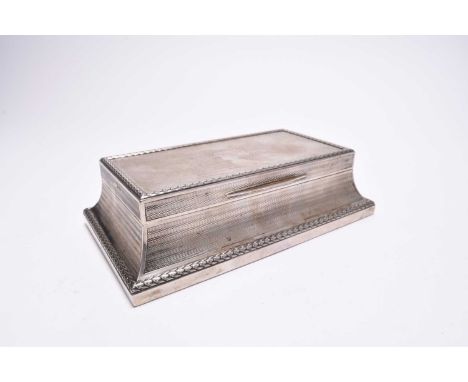 A silver mounted cigarette box, J B Ltd, London 1920, of tapered rectangular engine turned form with decorative border, 21cm 