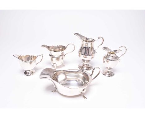 A small collection of silver, comprising; a silver sauce boat, Sheffield 1932, together with four silver cream jugs, total we