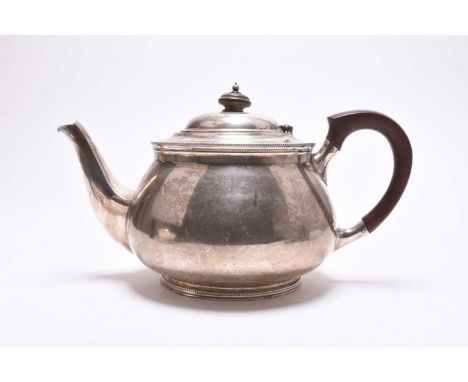 A silver teapot, Mappin &amp; Webb, Sheffield 1924, of circular form with turned wood handle and finial, 12cm high, weight ap