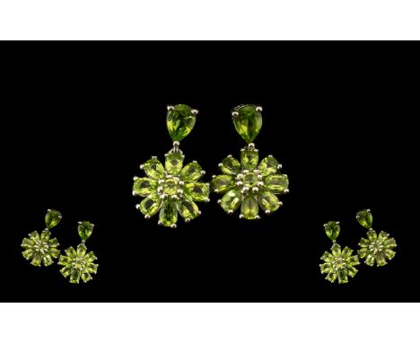 Peridot Flower Drop Earrings, each comprising a ring of pear cut peridots surrounding a round cut, resembling a stylised flow