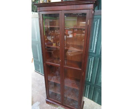 Modern mahogany finish bookcase, with two glazed doors and five adjustable shelves on bracket feet, W80cm D29cm H182cm 