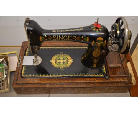 Singer sewing machine with unusual decoration in original wooden case, with instruction manual and spare bobbins 