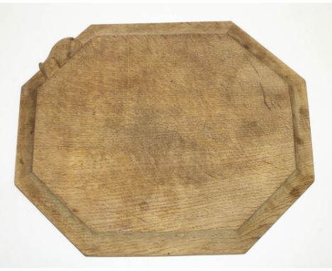 Robert Mouseman Thompson of Kilburn - an oak octagonal bread board, moulded edge carved with signature mouse, 30cm x 25.5cm 