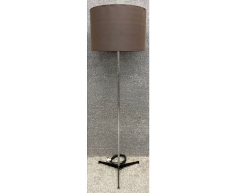A mid century standard lamp with original shade on a chrome and metal base. H.160cm