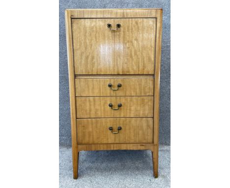 A mid century walnut Art Deco style drinks cabinet with a fall-front, opening to a mixing counter with fitted interior over t