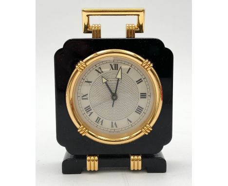 A Cartier Art Deco style black lacquer and gilt desk alarm clock, with its original box and certificate of authenticity. H.11