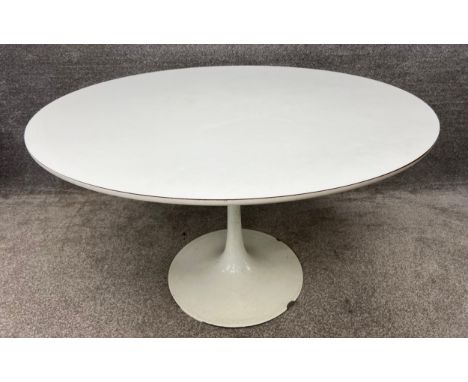 A vintage mid century white tulip table designed by Maurice Burke for Arkana, with a sprayed steel base, and a circular formi